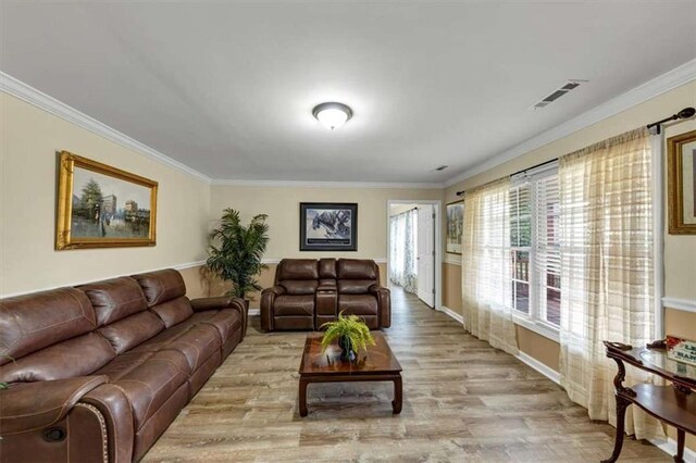 1131 Planing Mill Rd, Greensboro, GA 30642 - living room featuring ornamental molding, light wood-type flooring, and baseboards