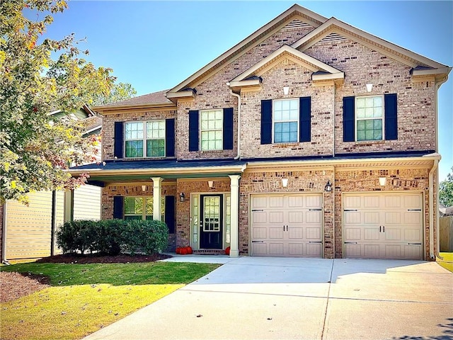 craftsman inspired home with a front lawn and a garage