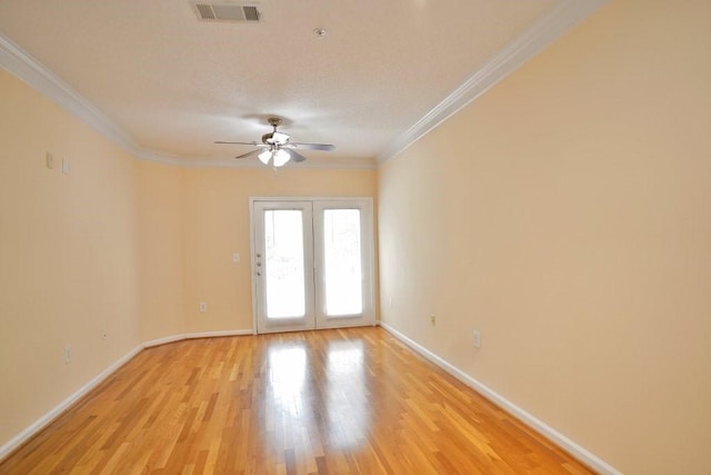 unfurnished room featuring ceiling fan, crown molding, french doors, and light hardwood / wood-style flooring