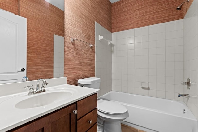 full bathroom with vanity, toilet, and tiled shower / bath combo