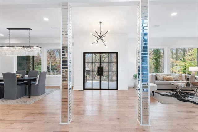 interior space featuring an inviting chandelier and light wood-type flooring