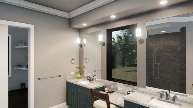 full bath featuring recessed lighting, a sink, a tile shower, double vanity, and crown molding