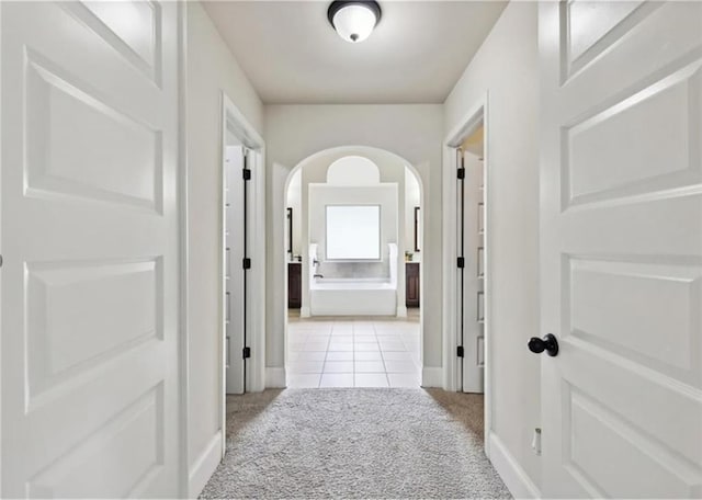 hallway with light colored carpet