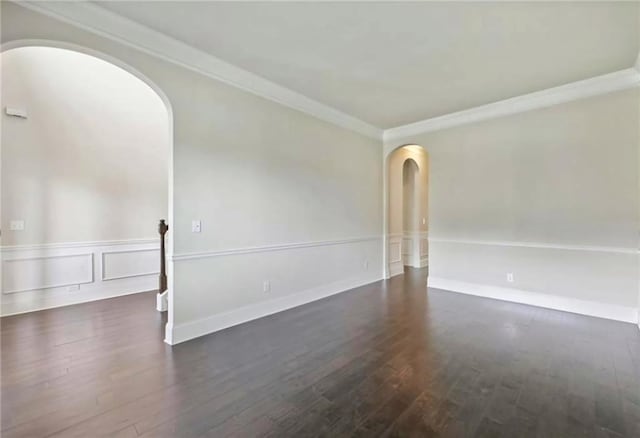 empty room with dark wood-type flooring and ornamental molding