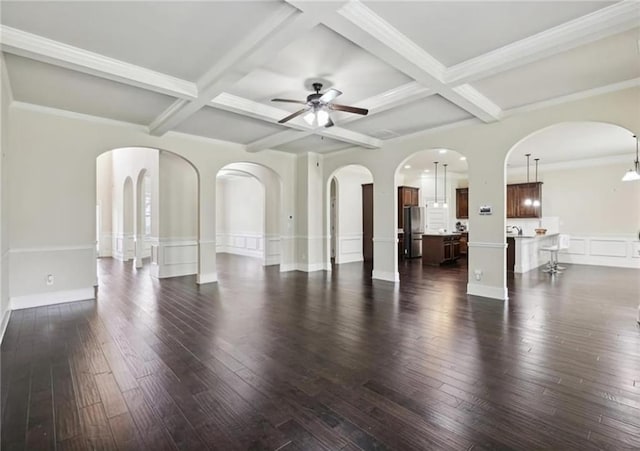 spare room featuring beamed ceiling, coffered ceiling, and dark wood-type flooring