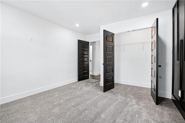 unfurnished bedroom with a closet and carpet