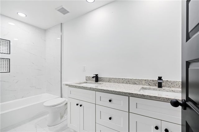 full bathroom featuring vanity, toilet, and tiled shower / bath combo