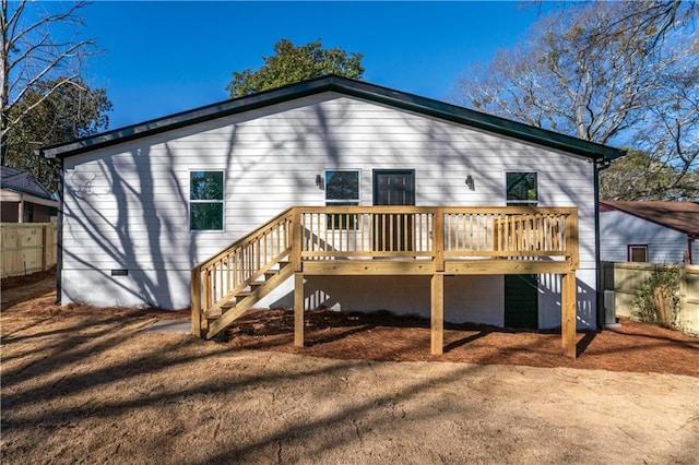 rear view of property featuring a wooden deck