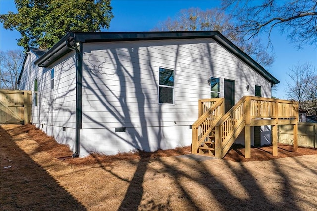 back of house with a wooden deck