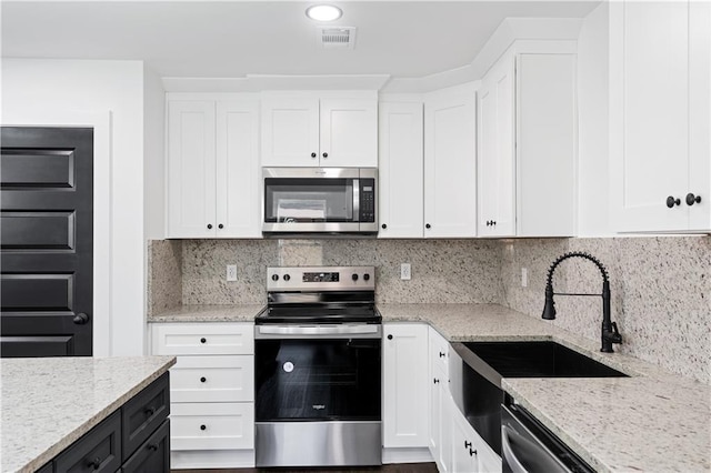 kitchen featuring white cabinetry and stainless steel appliances