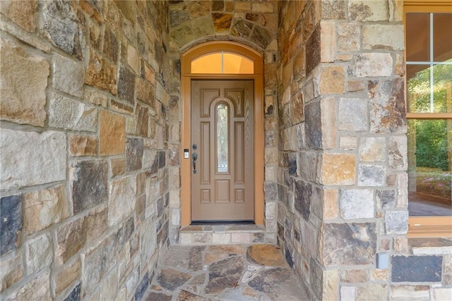 doorway to property featuring stone siding