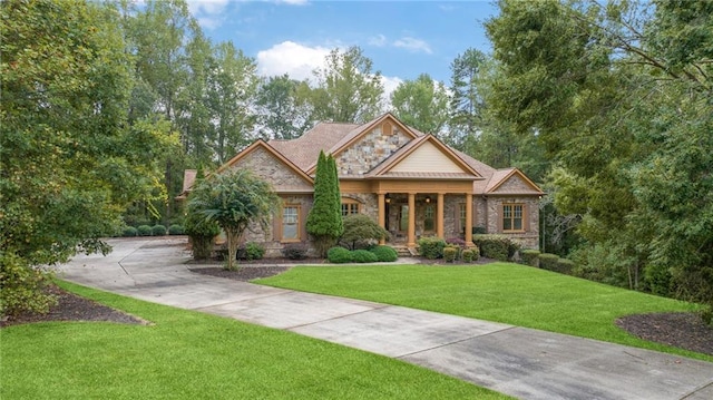 craftsman-style house featuring stone siding and a front lawn