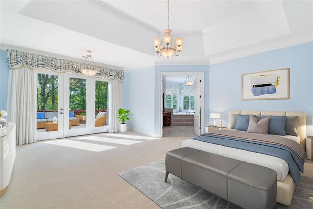 carpeted bedroom featuring ensuite bathroom, access to outside, a tray ceiling, crown molding, and french doors