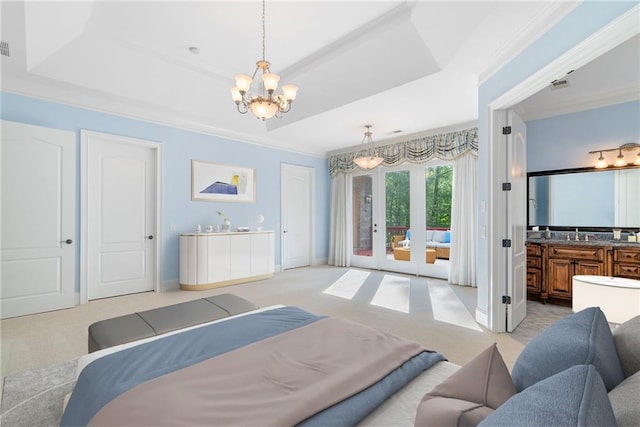 bedroom featuring access to exterior, a tray ceiling, a chandelier, and light colored carpet