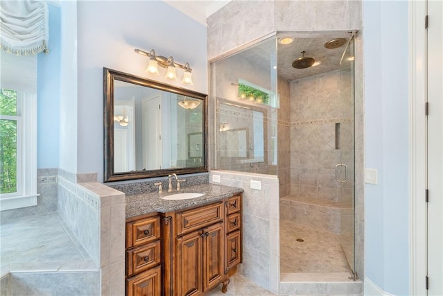 full bath with a stall shower and vanity