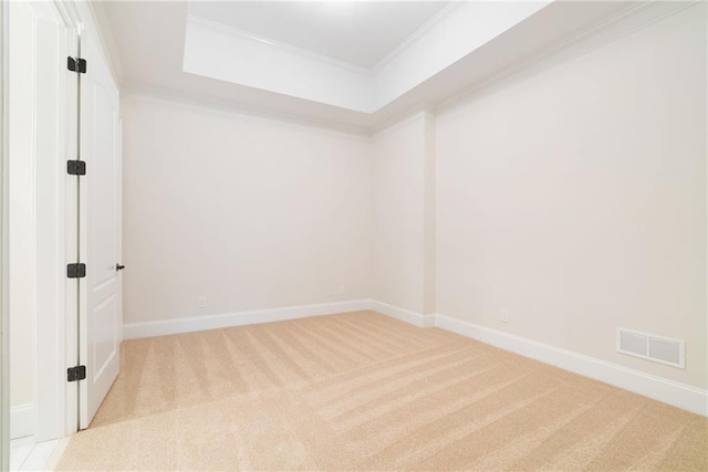 unfurnished room featuring light carpet, visible vents, ornamental molding, and baseboards