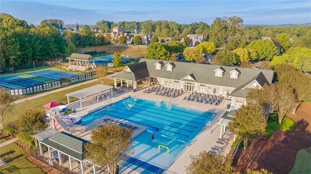 pool with a patio and fence