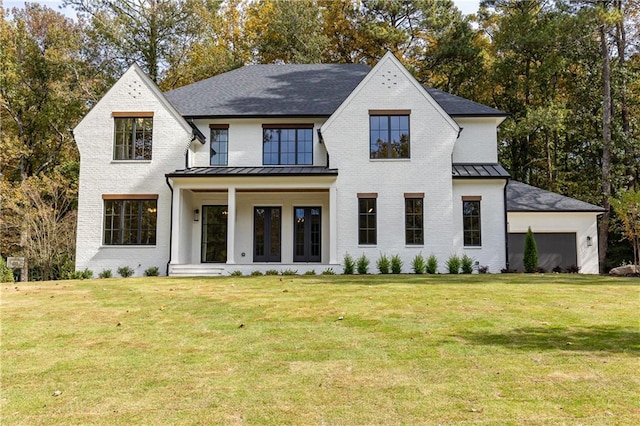 view of front of home with a garage and a front lawn