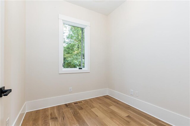 spare room featuring hardwood / wood-style floors