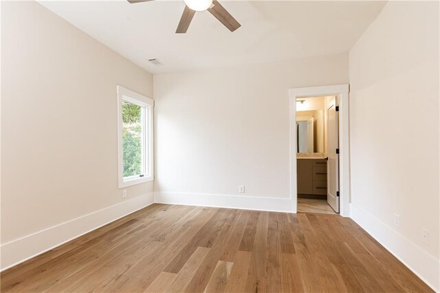 empty room featuring light wood-type flooring and ceiling fan