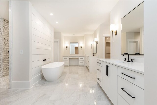 bathroom with vanity and a tub