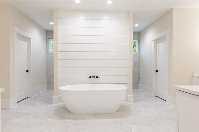 bathroom with vanity and independent shower and bath