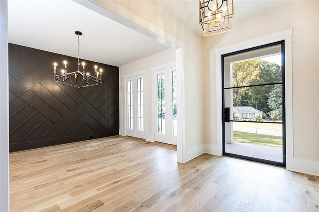 entryway featuring light hardwood / wood-style flooring and a notable chandelier