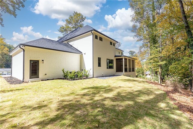 rear view of house with a yard