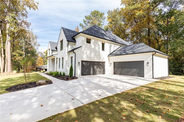 view of front of house featuring a garage and a front lawn