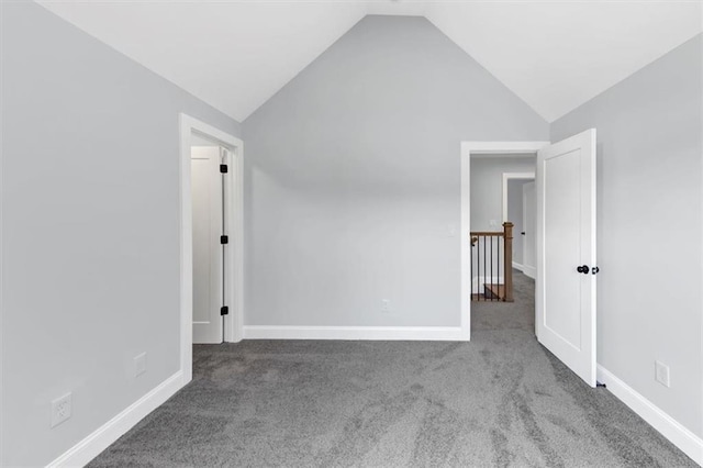 interior space with lofted ceiling, carpet, and baseboards