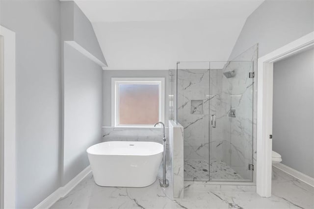 full bath with a marble finish shower, a freestanding bath, marble finish floor, and vaulted ceiling