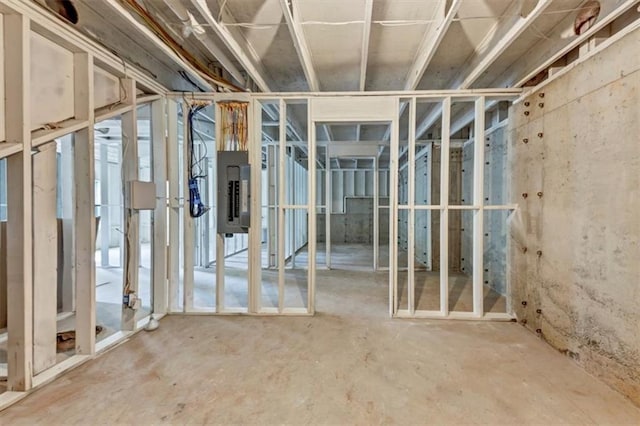 unfinished basement featuring electric panel