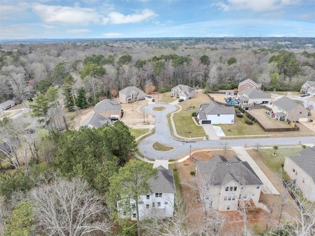 birds eye view of property featuring a view of trees