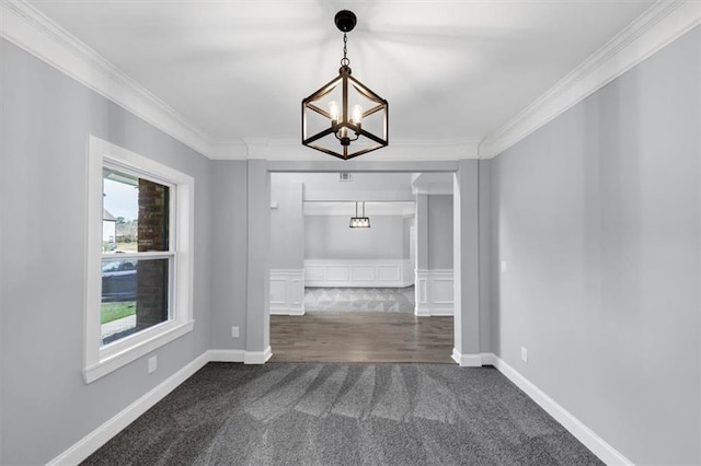 unfurnished dining area featuring baseboards, dark carpet, a chandelier, and crown molding