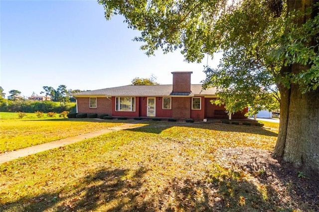 single story home with a front yard and a chimney