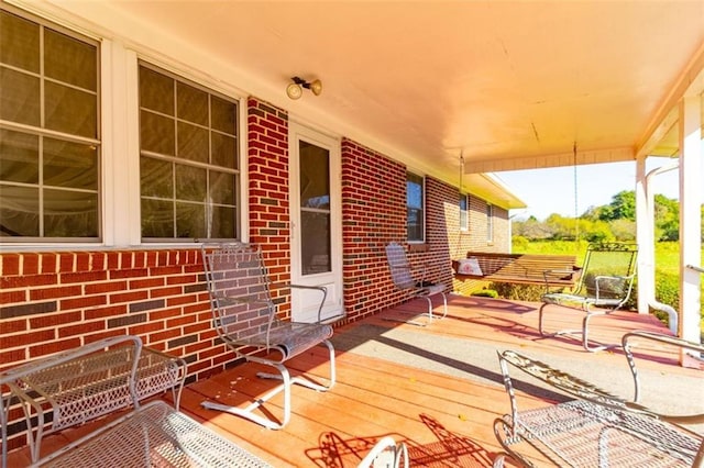 wooden terrace featuring covered porch