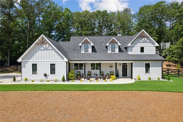 rear view of property with a yard and a porch