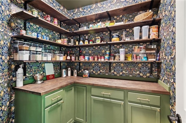 bar featuring wooden counters and green cabinets