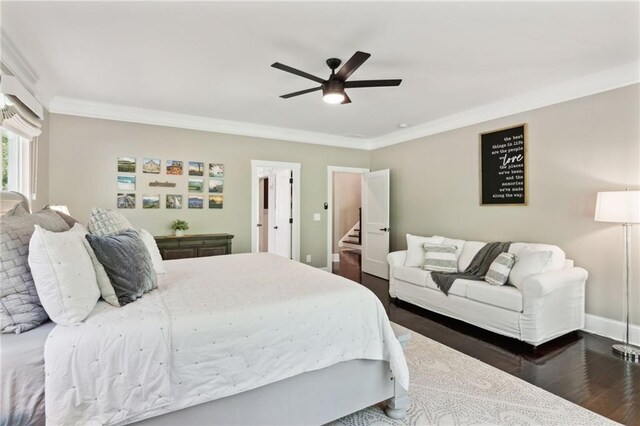 bedroom with ceiling fan, crown molding, and dark hardwood / wood-style flooring