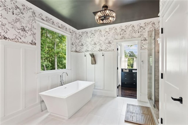 bathroom with tile patterned floors and shower with separate bathtub