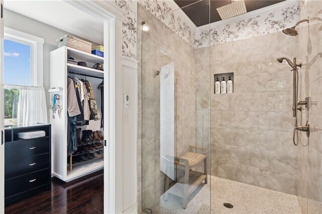 bathroom featuring a tile shower and hardwood / wood-style floors