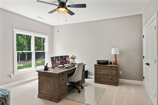 carpeted office with ceiling fan