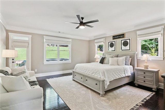 bedroom featuring dark wood-type flooring, crown molding, and ceiling fan