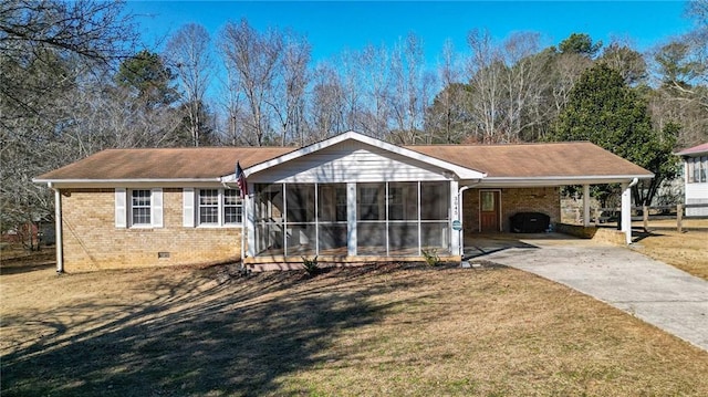 ranch-style house featuring a sunroom, a front yard, and a carport