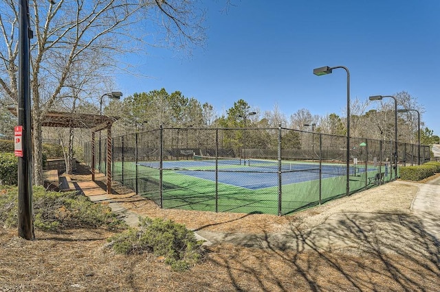 view of tennis court with fence