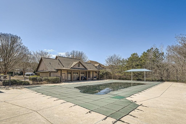 pool featuring fence and a patio