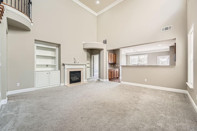 unfurnished living room with light carpet, baseboards, visible vents, and crown molding