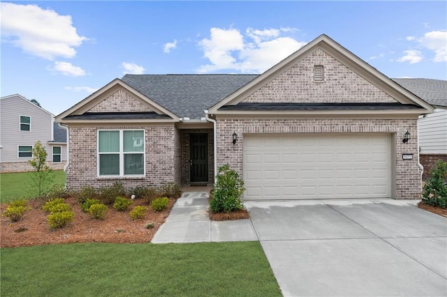 view of front of house with concrete driveway, a front lawn, an attached garage, and brick siding