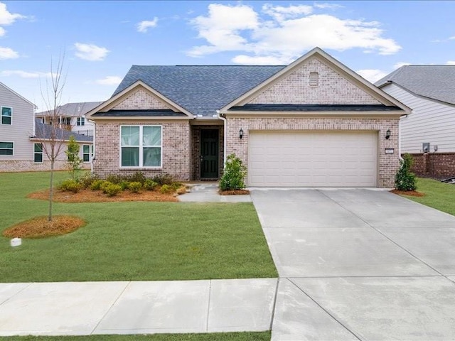 view of front of house featuring a garage, brick siding, concrete driveway, and a front yard