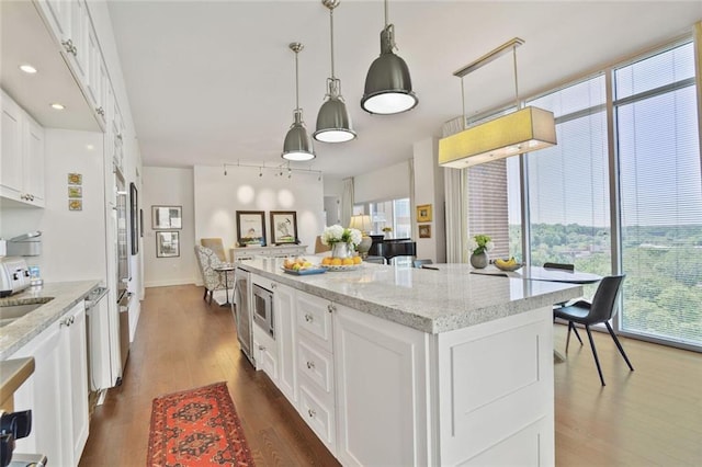 1820 Peachtree St NW Unit 1008, Atlanta, GA 30309 - kitchen with healthy amount of natural light, dark wood-style floors, and a center island